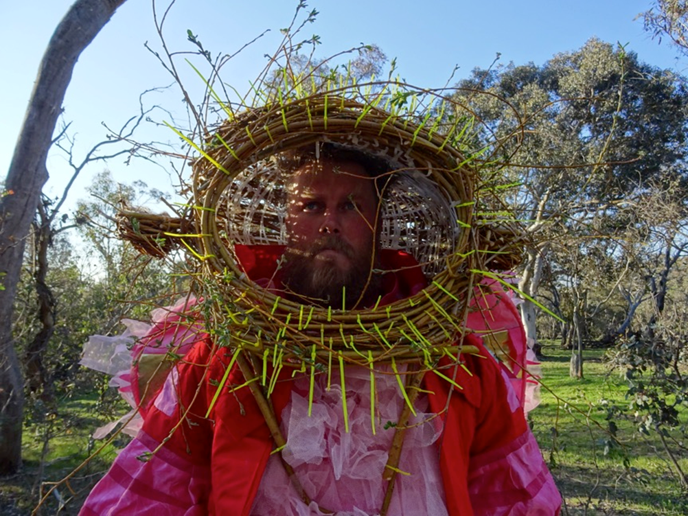 Hanna Hoyne & Byrd: Byrd with Nesting Helmet (2015). Byrd shown in performance at Mount Majura Reserve. Crace Field Study adjunct to the ANU Environment Studio, Canberra. Photo: Hanna Hoyne.